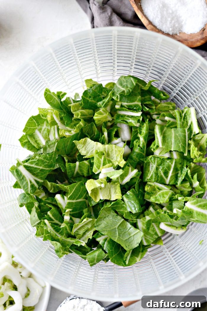 Chopped and rinsed bok choy leaves in a colander