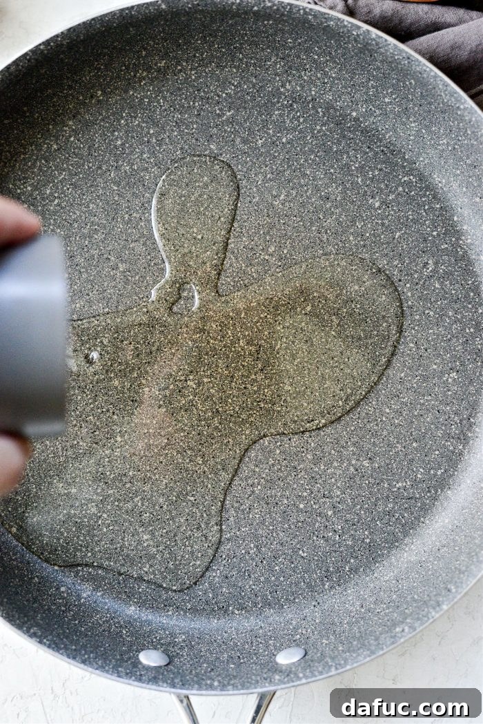 Olive oil being poured into a skillet