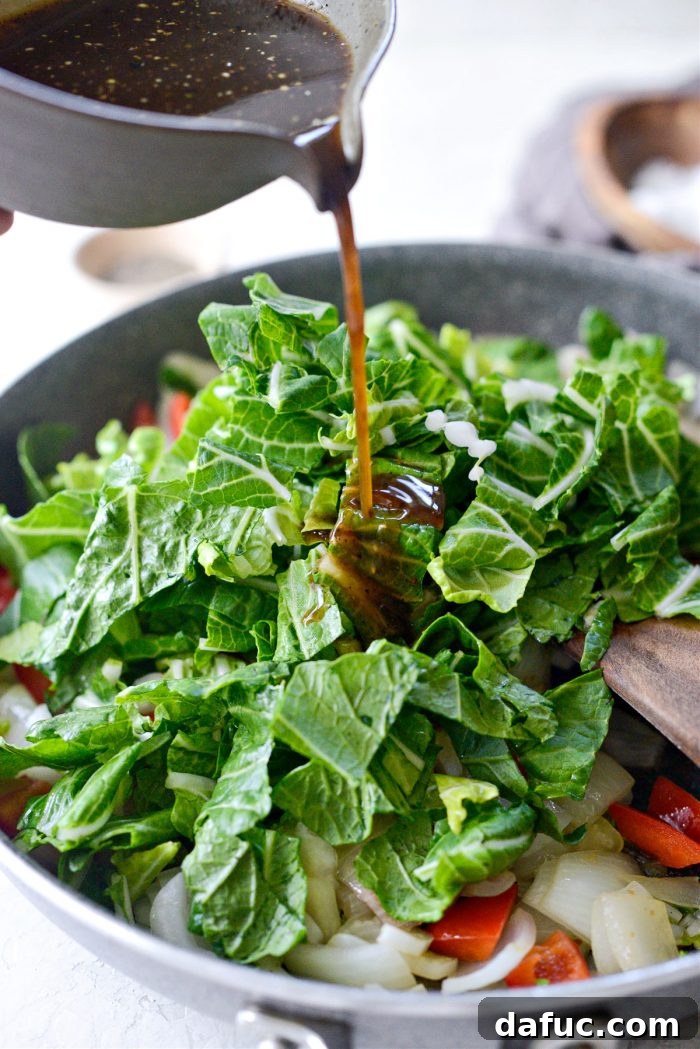 Bok choy leaves and black pepper sauce being added to stir-fry