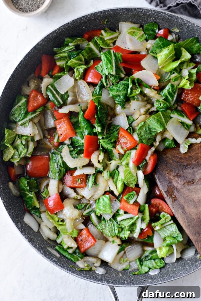 Stir-fry being tossed until bok choy leaves are slightly wilted