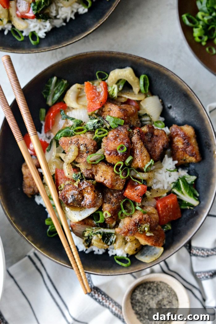 Overhead view of Black Pepper Chicken Stir-fry with chopsticks