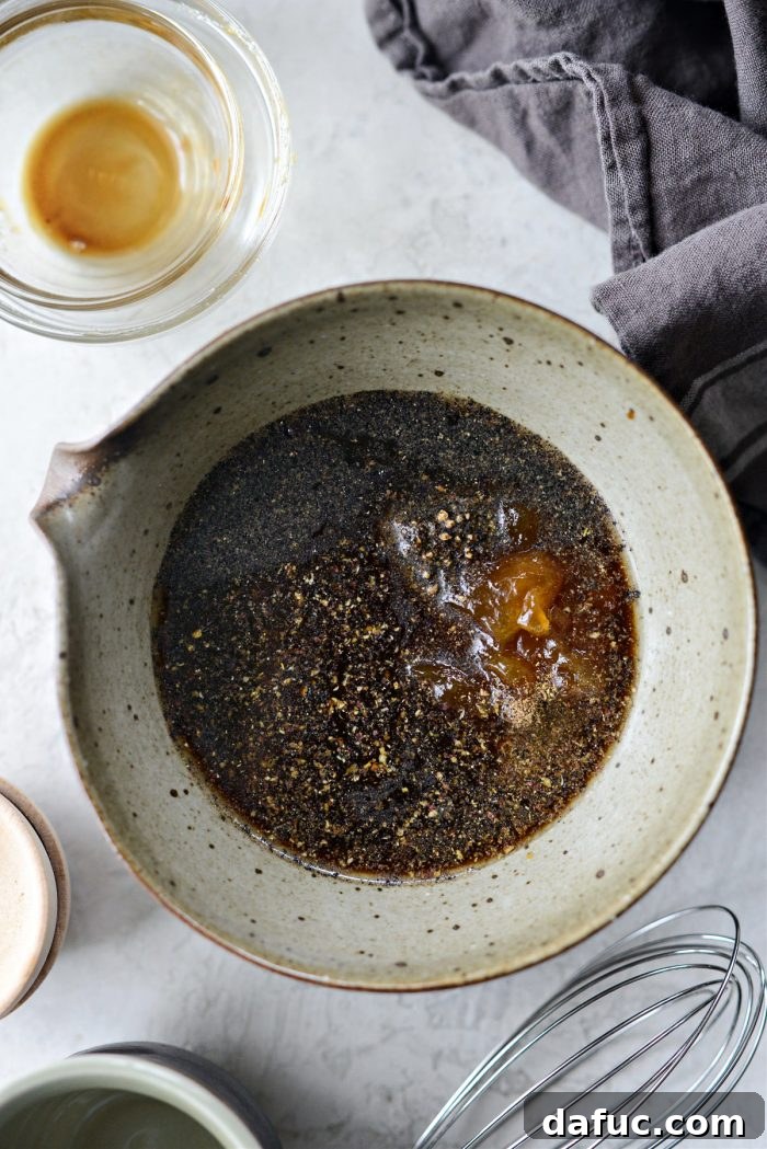 Ingredients for black pepper chicken sauce measured in a bowl