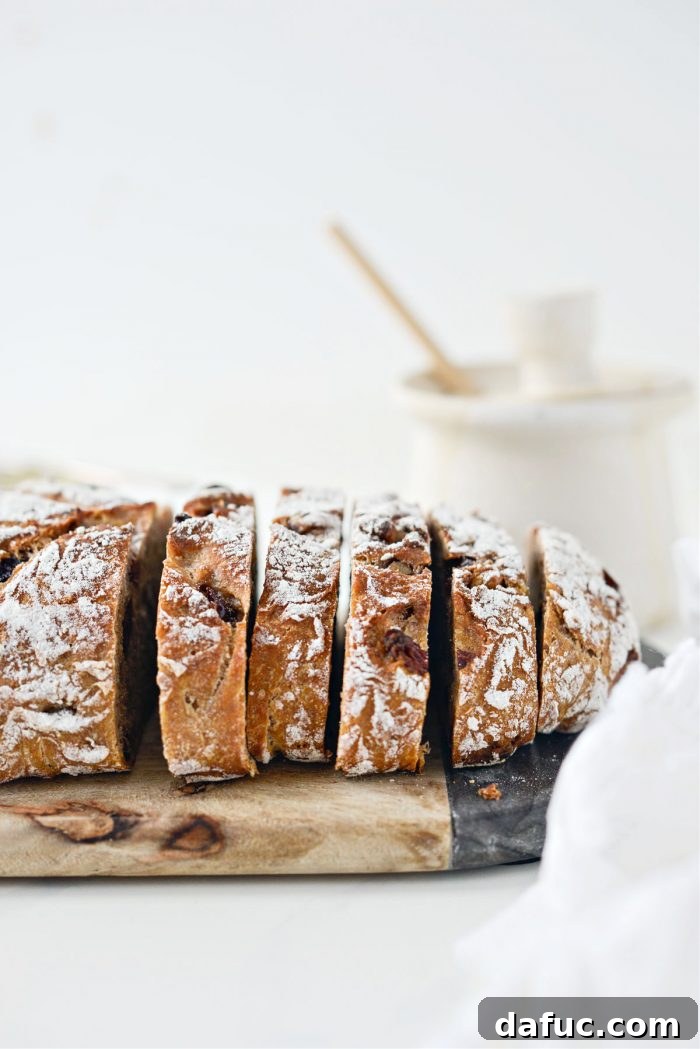 Effortless Cranberry Walnut Loaf 21 Slice of No-Knead Cranberry Walnut Bread on a cutting board