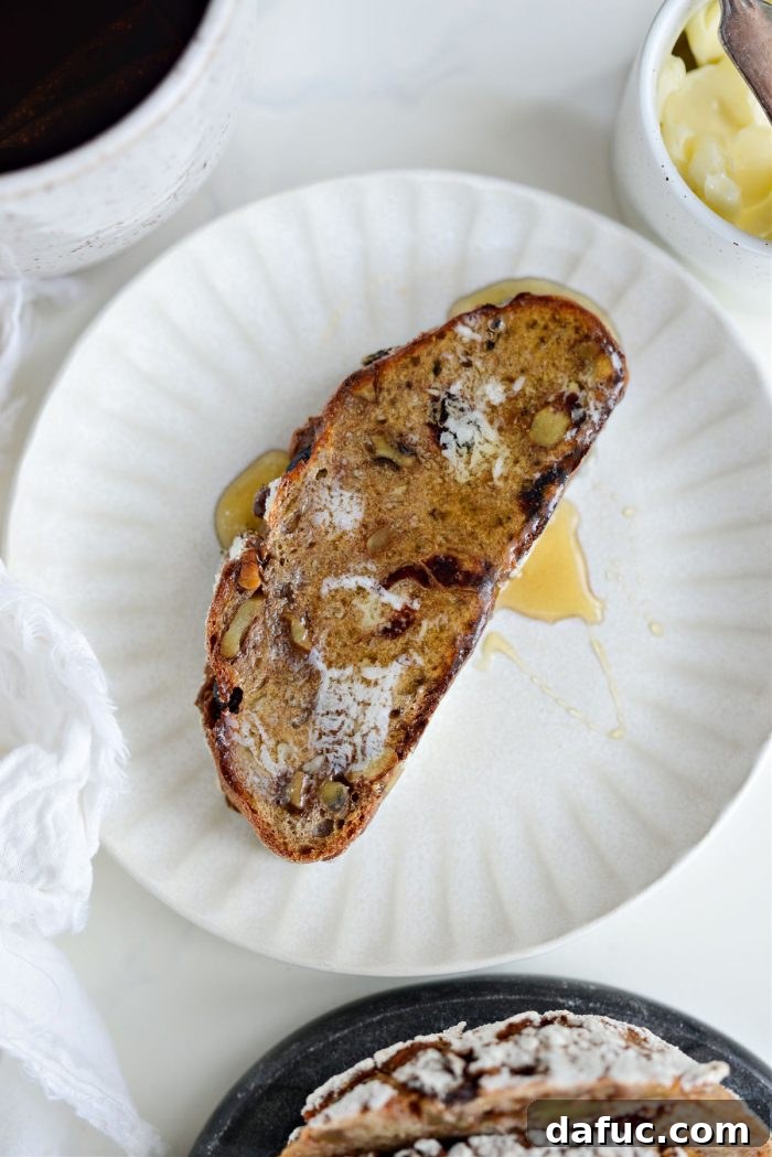 Effortless Cranberry Walnut Loaf 23 Full loaf of No-Knead Cranberry Walnut Bread on a wooden cutting board