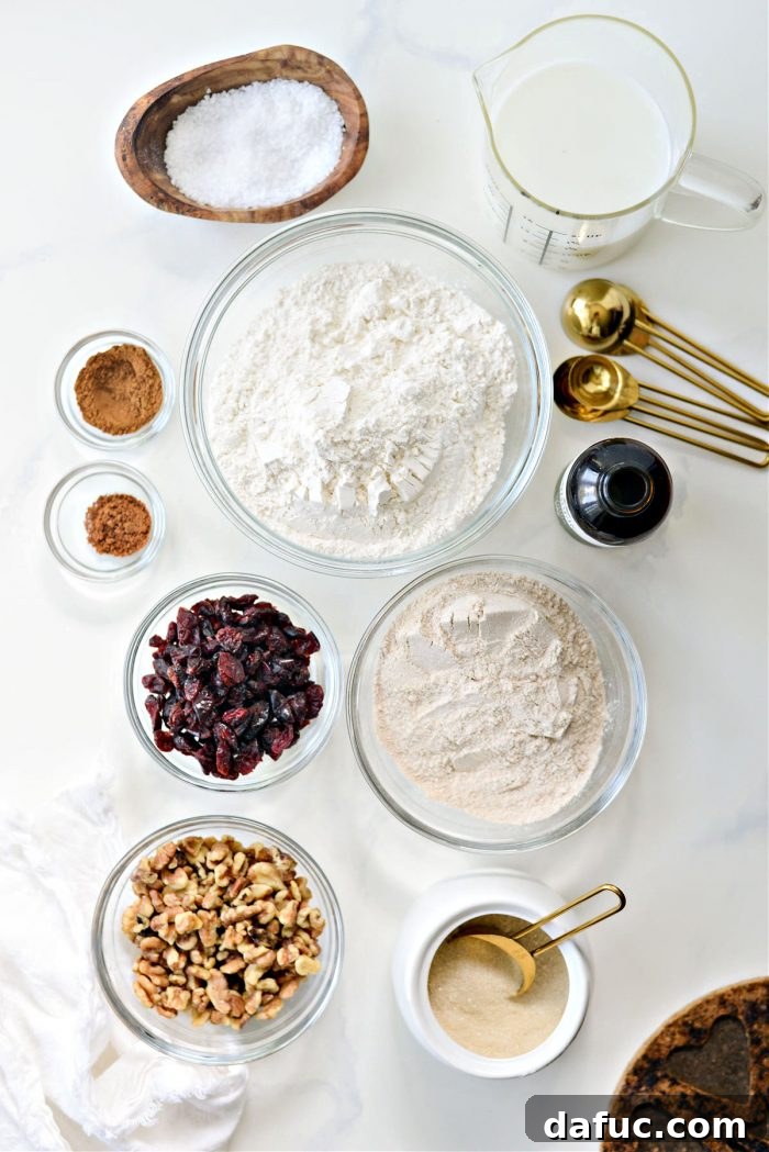 Effortless Cranberry Walnut Loaf 4 Ingredients laid out for No-Knead Cranberry Walnut Bread: flours, sugar, spices, dried cranberries, toasted walnuts, milk, water, vanilla
