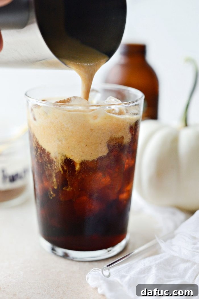Fall's Creamy Pumpkin Brew 14 Pouring pumpkin cold foam over cold brew coffee