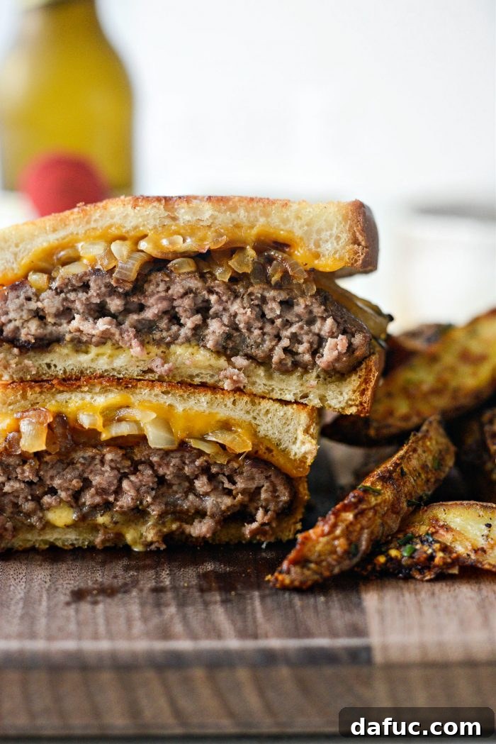 The Ultimate Beef Patty Melt 2 Classic Beef Patty Melt with golden griddled bread and oozing cheese, sliced in half