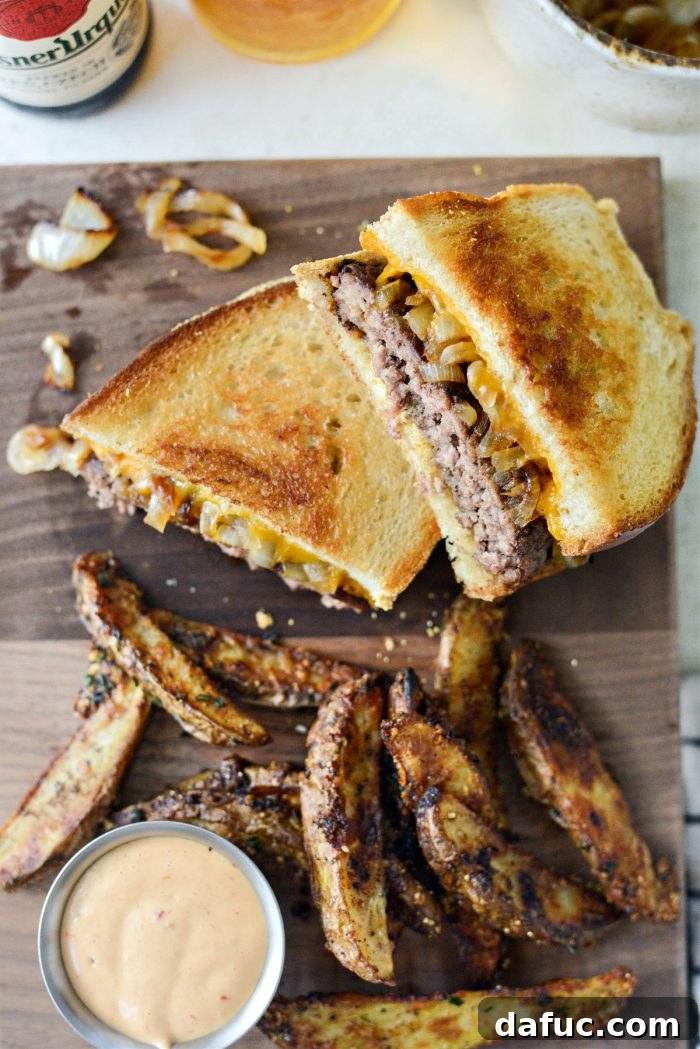 The Ultimate Beef Patty Melt 20 Classic Beef Patty Melt served on a plate with a side of golden French fries