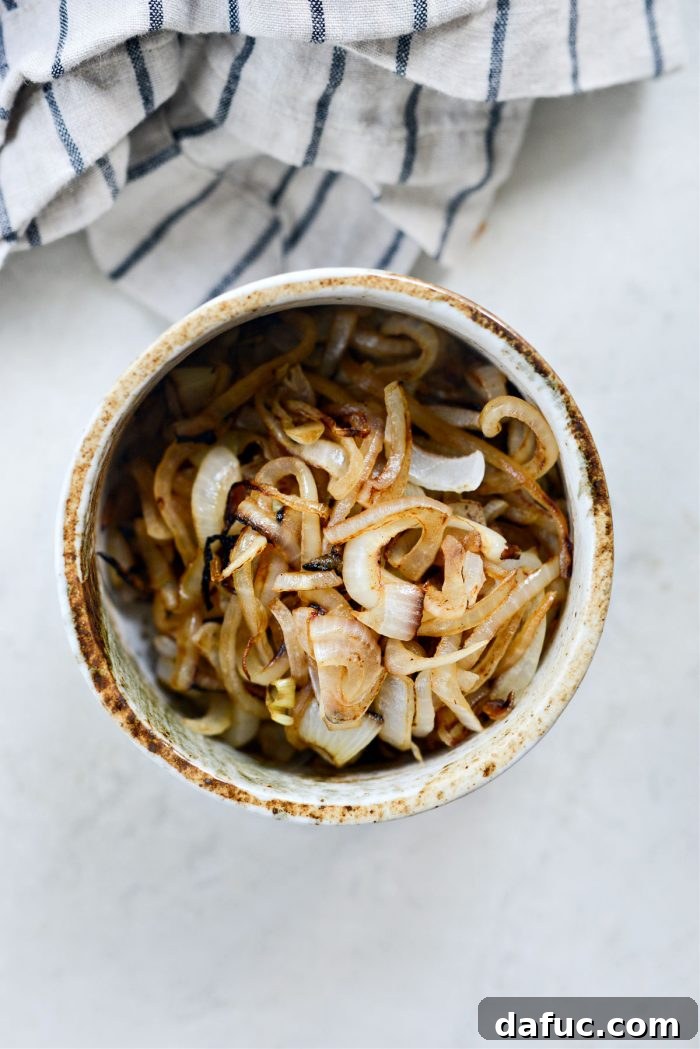 The Ultimate Beef Patty Melt 9 Cooked, deeply browned caramelized onions resting in a bowl