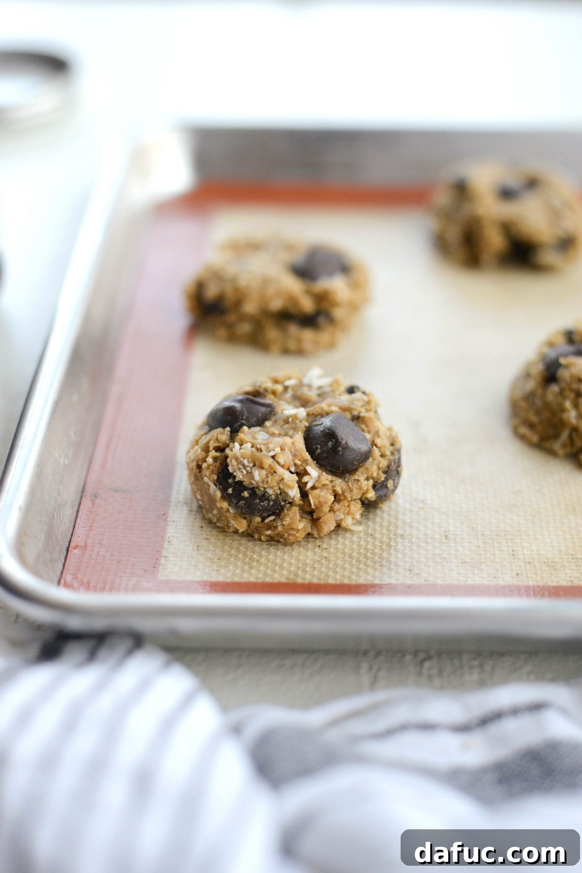Golden Toffee Oatmeal Chocolate Chip Cookies 18 Using a cookie scoop to portion out perfectly sized balls of cookie dough onto a baking sheet.
