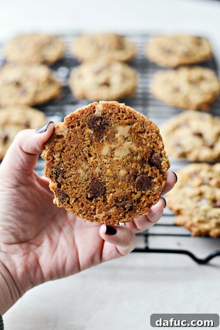 Golden Toffee Oatmeal Chocolate Chip Cookies 22 A delightful arrangement of Oatmeal Chocolate Chip Toffee Cookies, showcasing their rich texture and enticing toppings, on a rustic background.