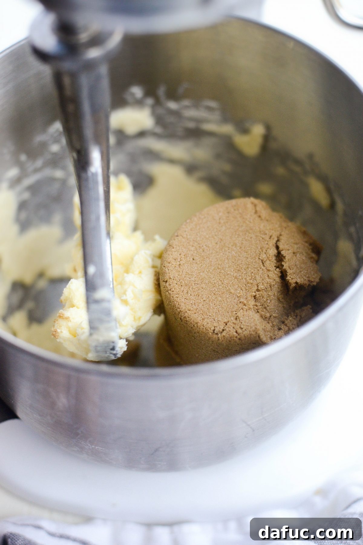 Golden Toffee Oatmeal Chocolate Chip Cookies 7 Creaming softened unsalted butter in a stand mixer, achieving a light and airy base for the cookie dough.