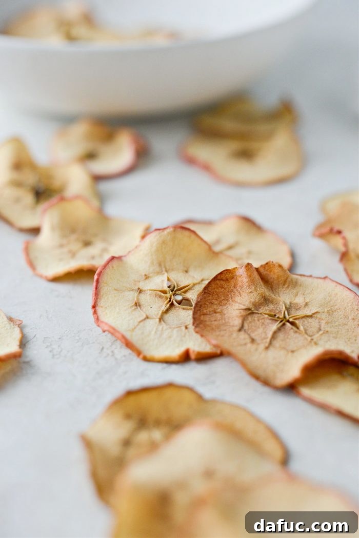 A bowl overflowing with fresh, vibrant red and green apples, perfect for making chips