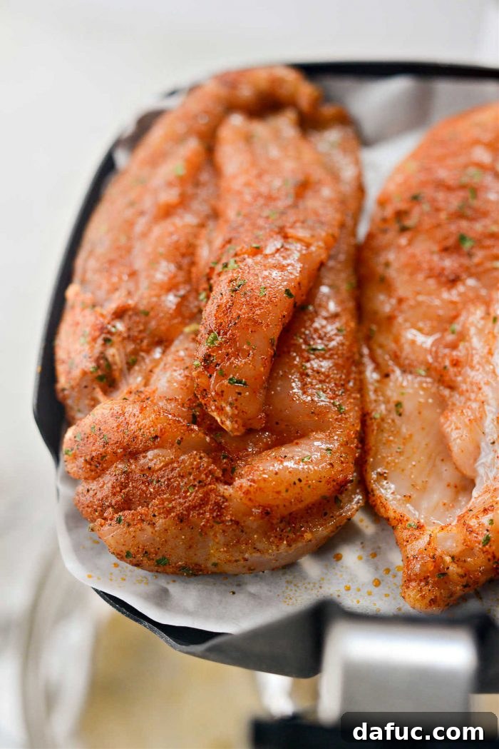 Chicken breasts cooking in an air fryer.