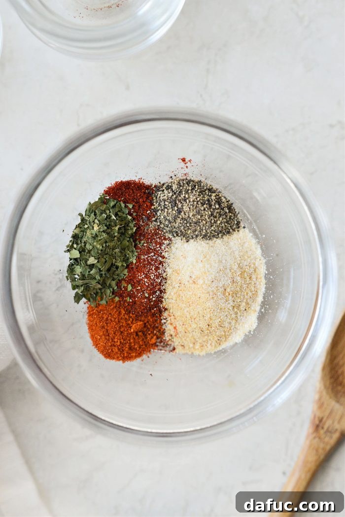 A bowl containing a custom spice blend for chicken.