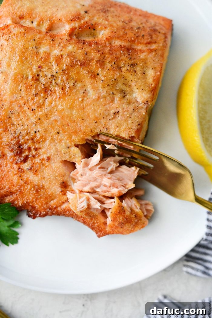 Easy Air Fryer Salmon 14 A final close-up of air fryer salmon on a plate, garnished and ready to eat.