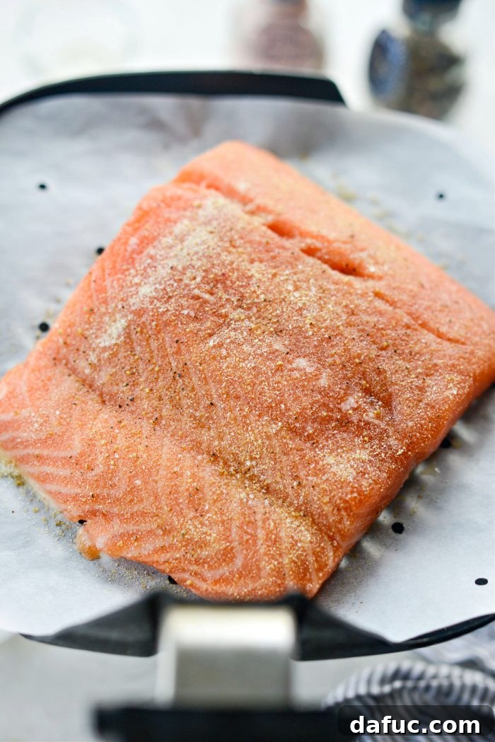 Easy Air Fryer Salmon 9 Salmon filet cooking in the air fryer basket.
