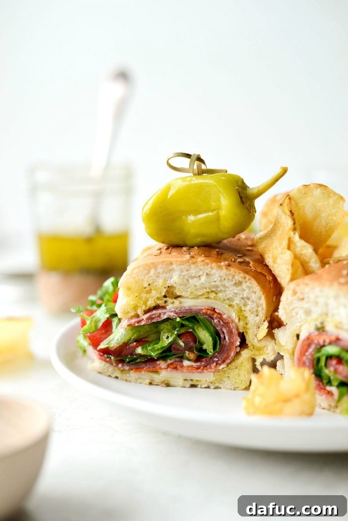 Zesty Italian Heroes 2 close up of italian sub sandwich with chips and peperoncini