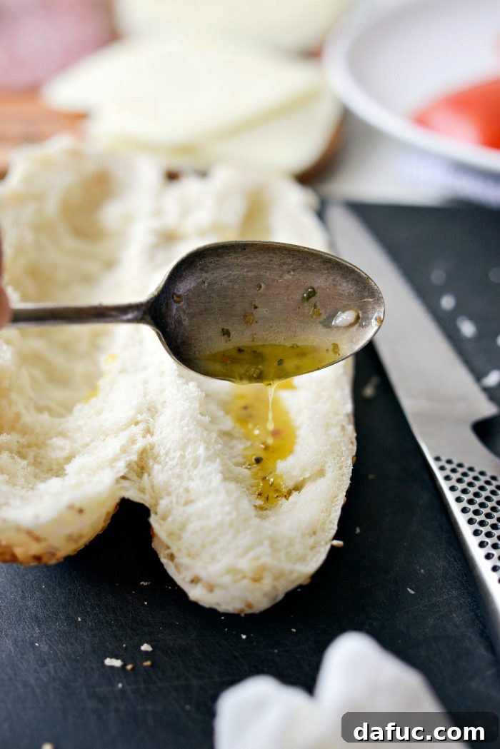 Zesty Italian Heroes 11 italian dressing spooned onto inside of sub bun