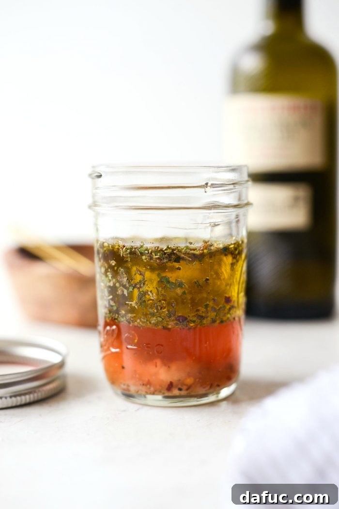 Zesty Italian Heroes 7 red wine vinegar and olive oil added to jar