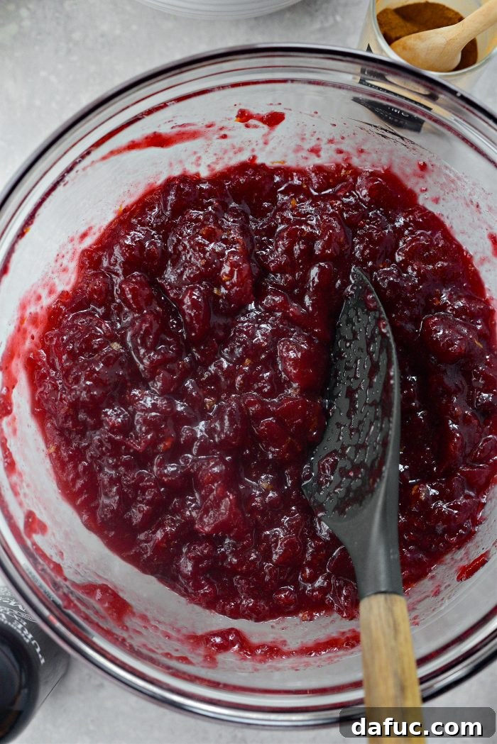 Crimson Kitchen 12 The mixed cranberry filling, a vibrant red color, in a bowl and ready to be spread onto the crust.