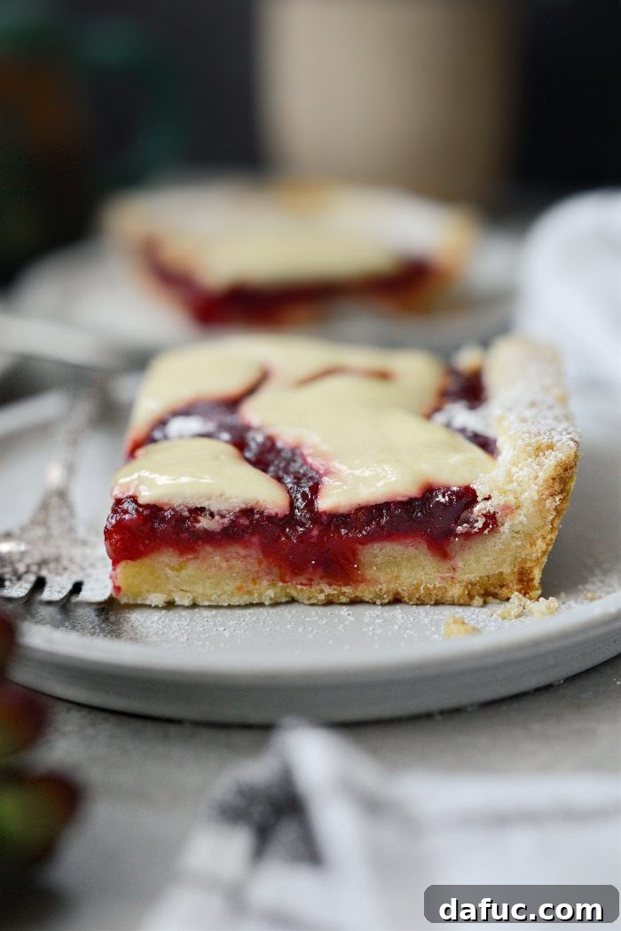 Crimson Kitchen 20 Beautifully arranged slices of Cranberry Küchen on a serving platter, ready for guests.