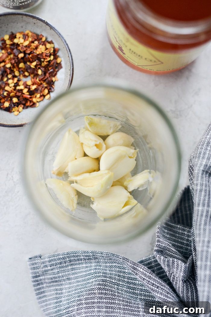 Sweet Heat Garlic Honey 5 Smashed garlic cloves in a clear pint jar