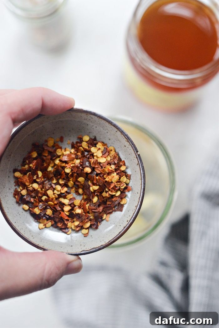 Sweet Heat Garlic Honey 6 Red pepper flakes being measured