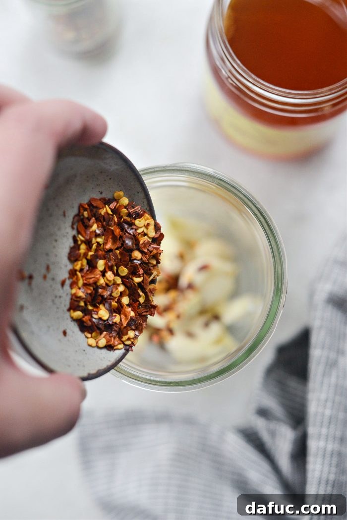 Sweet Heat Garlic Honey 7 Red pepper flakes added to the jar with garlic