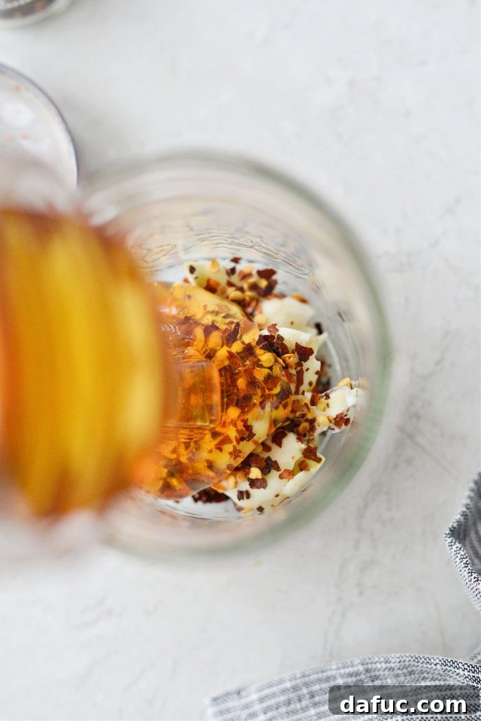 Sweet Heat Garlic Honey 8 Good quality honey being poured into the jar