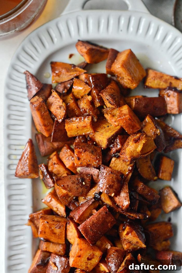 Beautifully caramelized Cinnamon Roasted Hot Honey Sweet Potatoes on a rustic serving platter