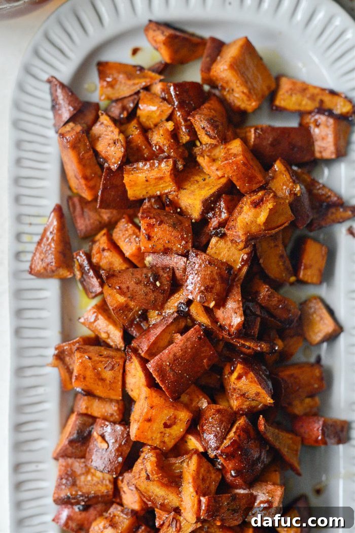 Close-up of a single serving of Cinnamon Roasted Hot Honey Sweet Potatoes on a small plate