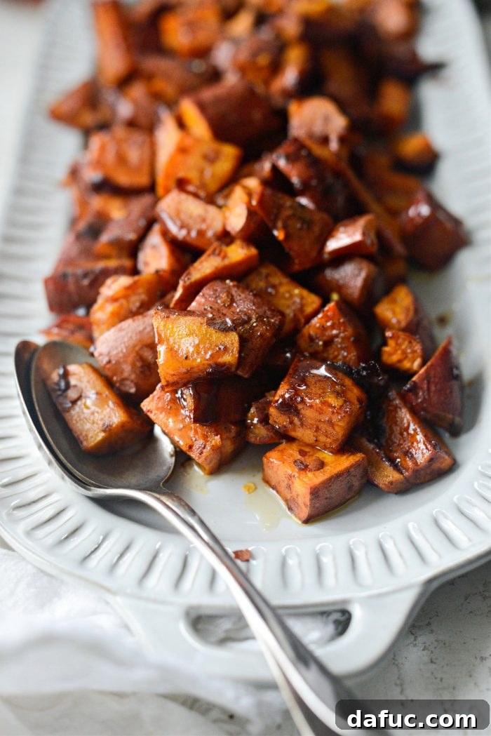 Close-up shot of hot honey glazed roasted sweet potatoes, highlighting the sticky texture