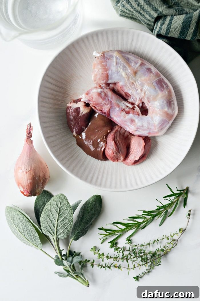 Close-up of raw turkey giblets including heart, gizzard, and liver, alongside the neck