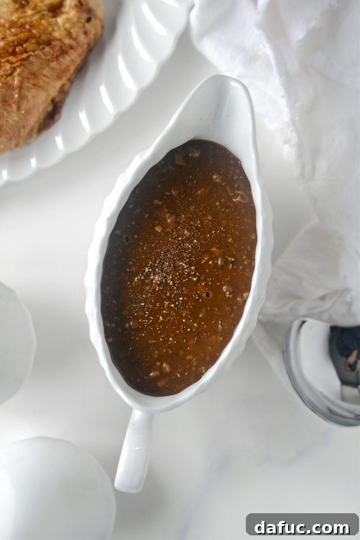 Homemade giblet gravy thickening to a perfect consistency in a skillet
