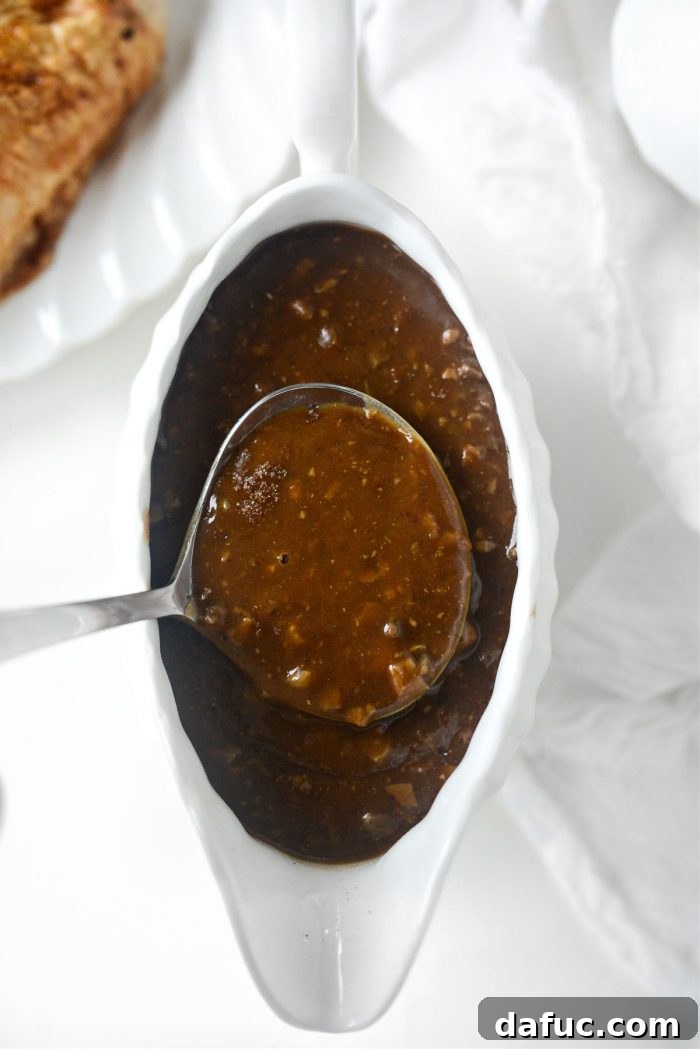 Close-up view of homemade giblet gravy being scooped with a spoon