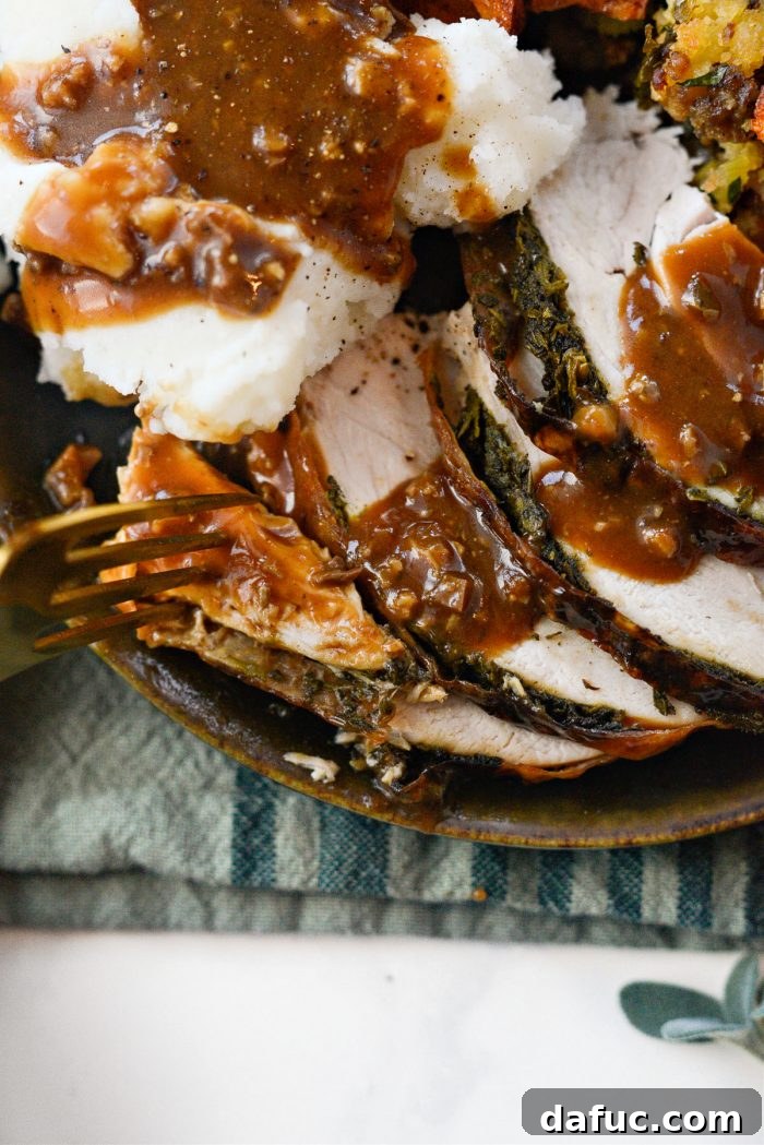 A perfectly roasted apple and herb turkey, ready to be carved and served with gravy