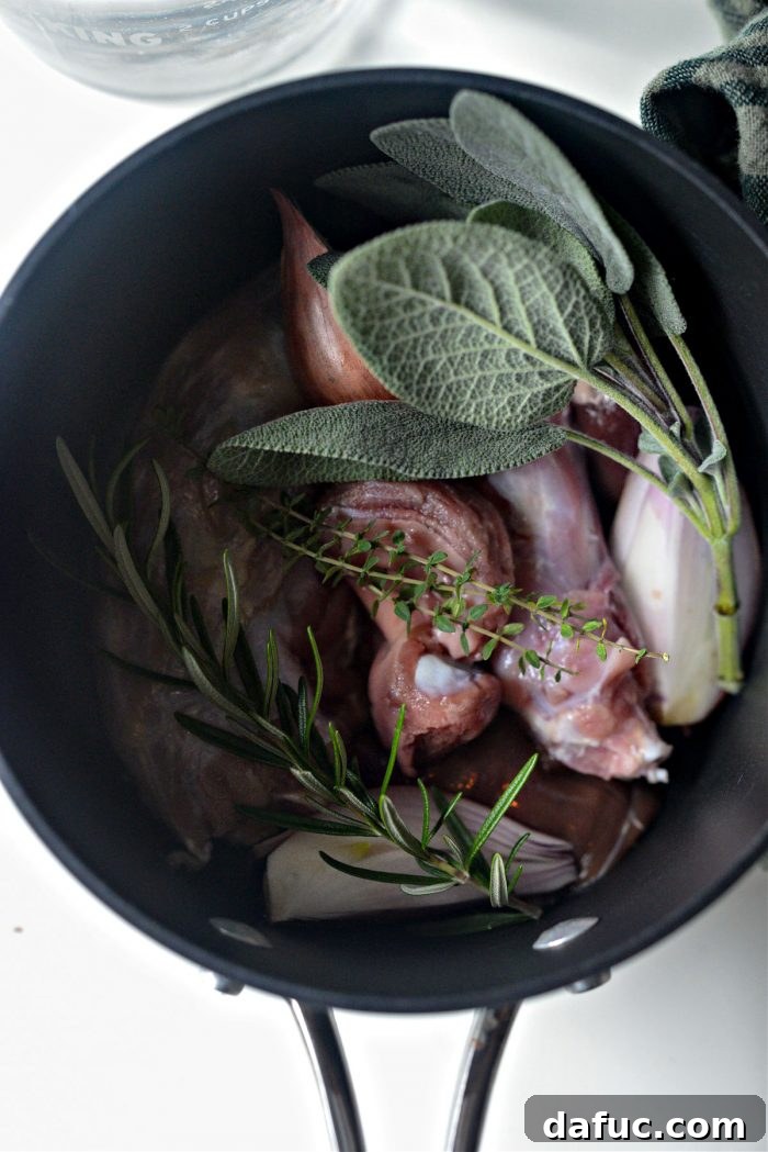 A selection of fresh ingredients for giblet gravy, including herbs, shallots, butter, and flour