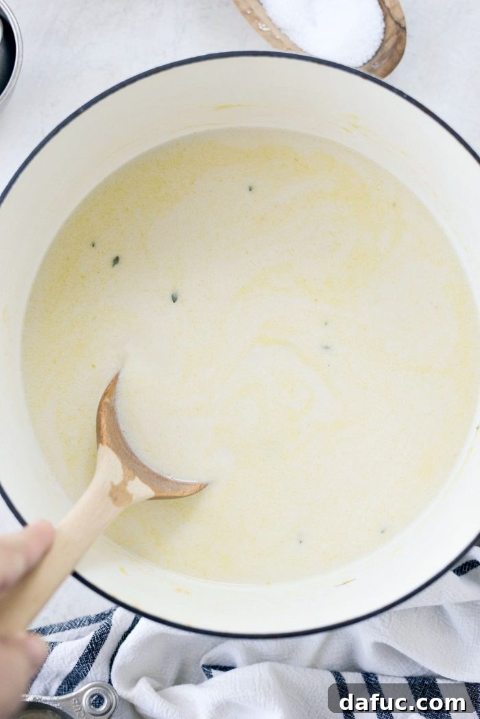 Whole milk being added to the pot pie filling, creating a creamy texture.