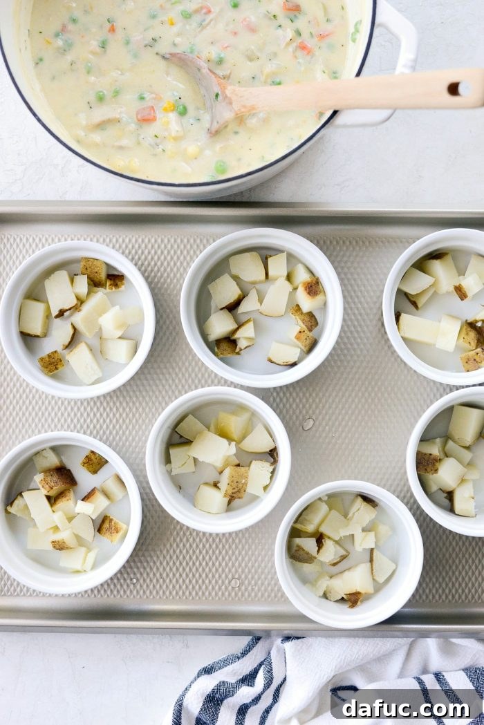 Diced cooked potatoes placed at the bottom of ramekins.