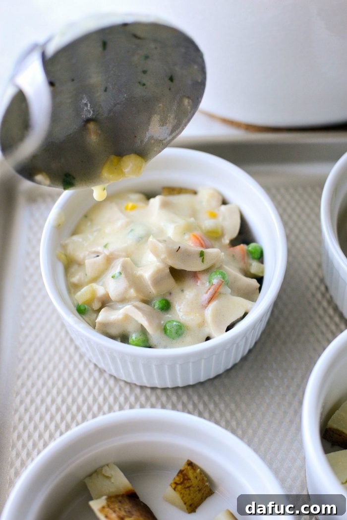 Ramekins filled to the brim with chicken pot pie filling.