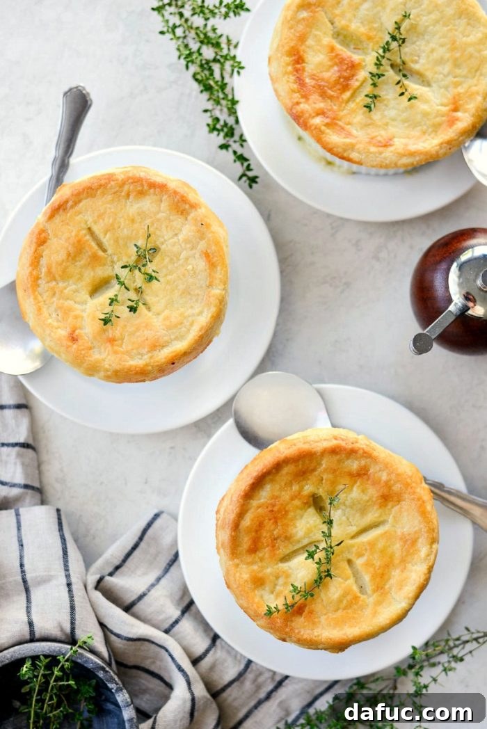 A perfectly baked homemade chicken pot pie with a golden, flaky crust, garnished with fresh parsley.