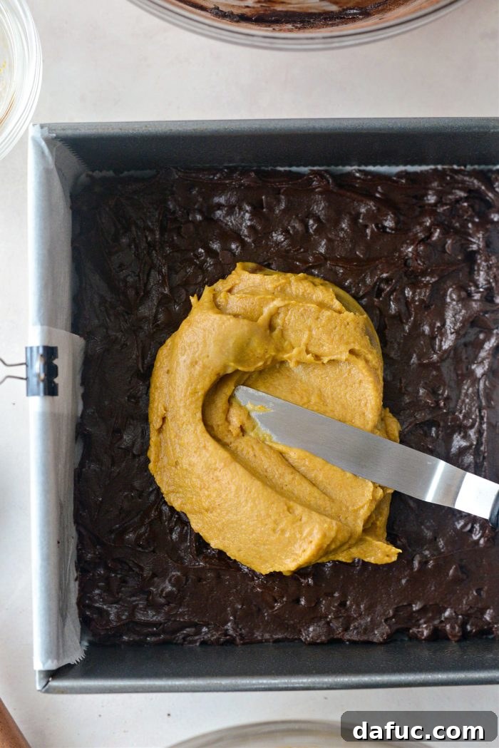 Spiced Pumpkin Pecan Brownies 20 Spreading half the brownie and half the pumpkin batter