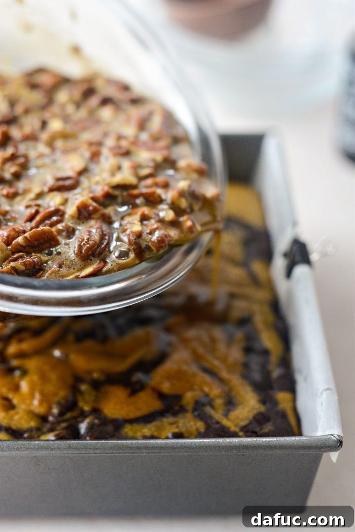 Spiced Pumpkin Pecan Brownies 32 Pouring pecan filling over partially baked brownies