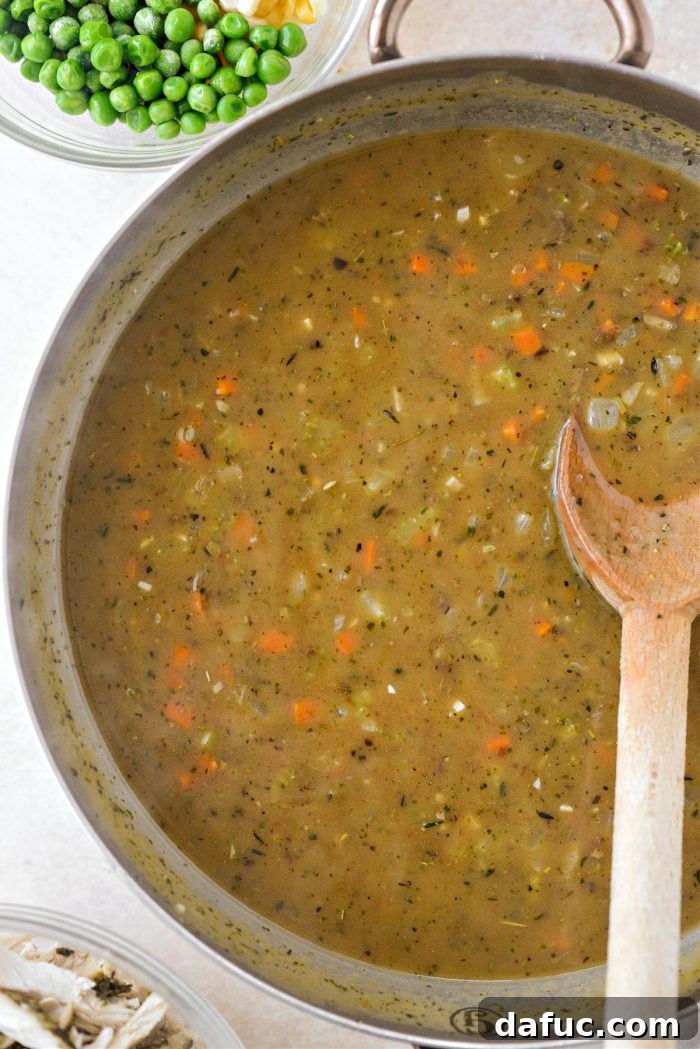 Stirring gravy into the turkey filling until well combined and smooth