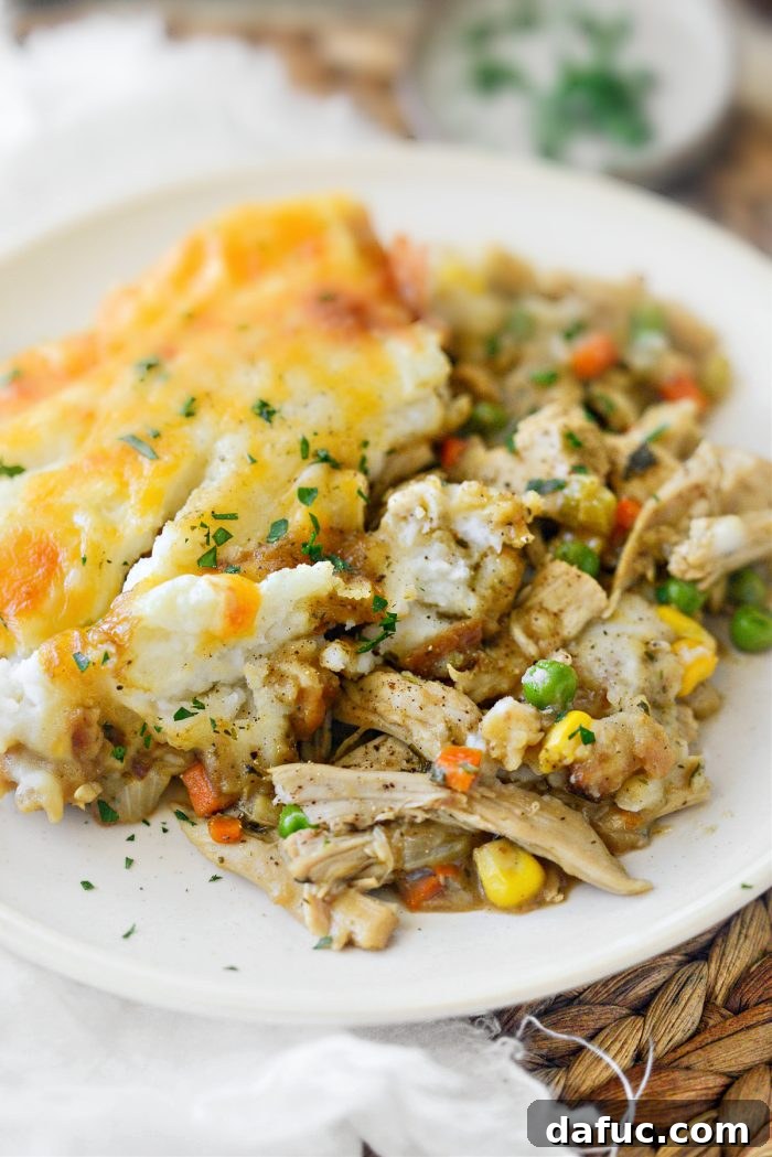 Close-up of a serving of Leftover Turkey Shepherd's Pie Casserole, beautifully garnished with fresh parsley