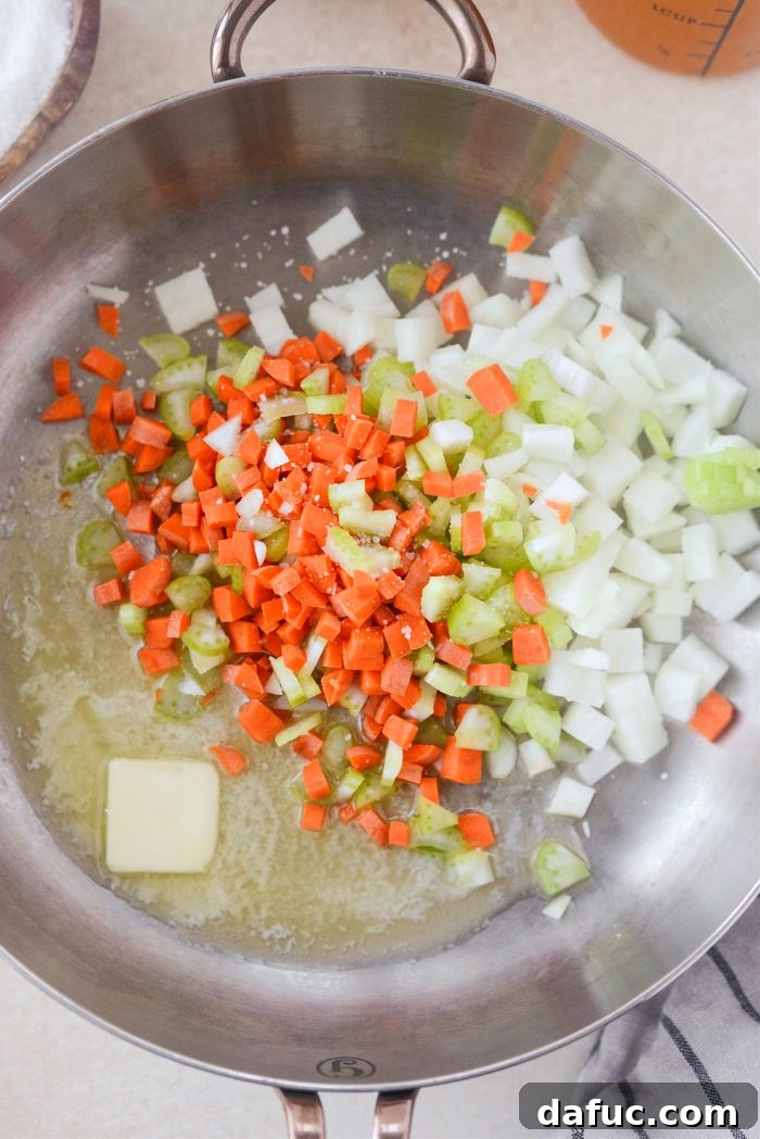 Sautéing butter, carrots, celery, and onion in a skillet for the base of the turkey shepherd's pie filling