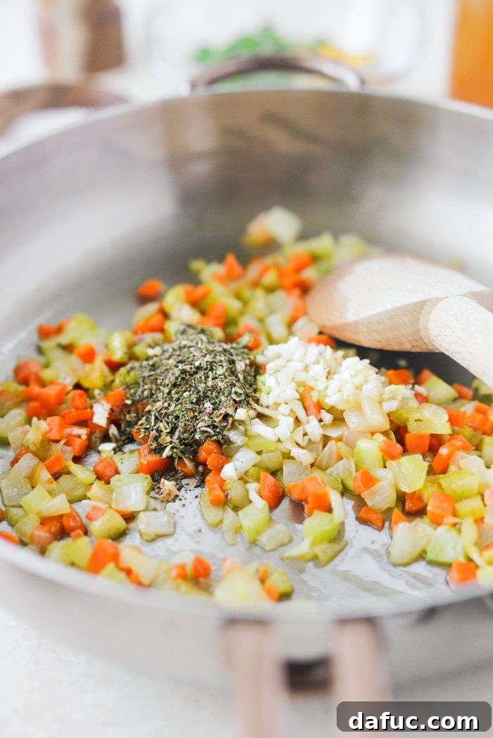 Adding poultry seasoning to the sautéed vegetables for the turkey pie filling