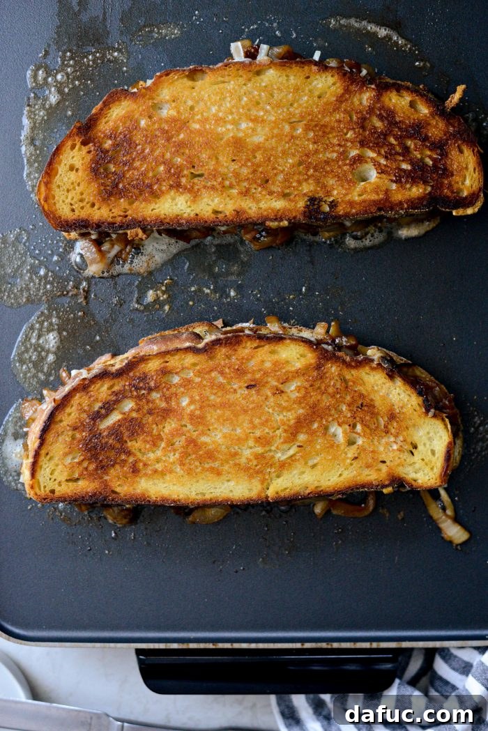 Golden brown grilled cheese on griddle