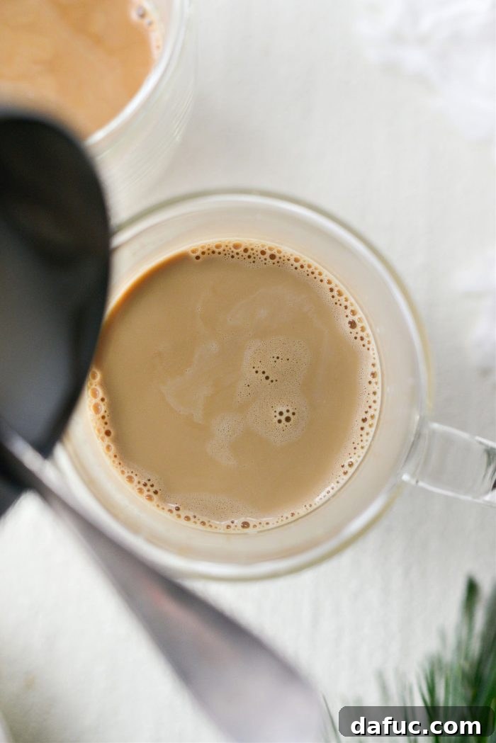 Steamed milk poured into eggnog and espresso